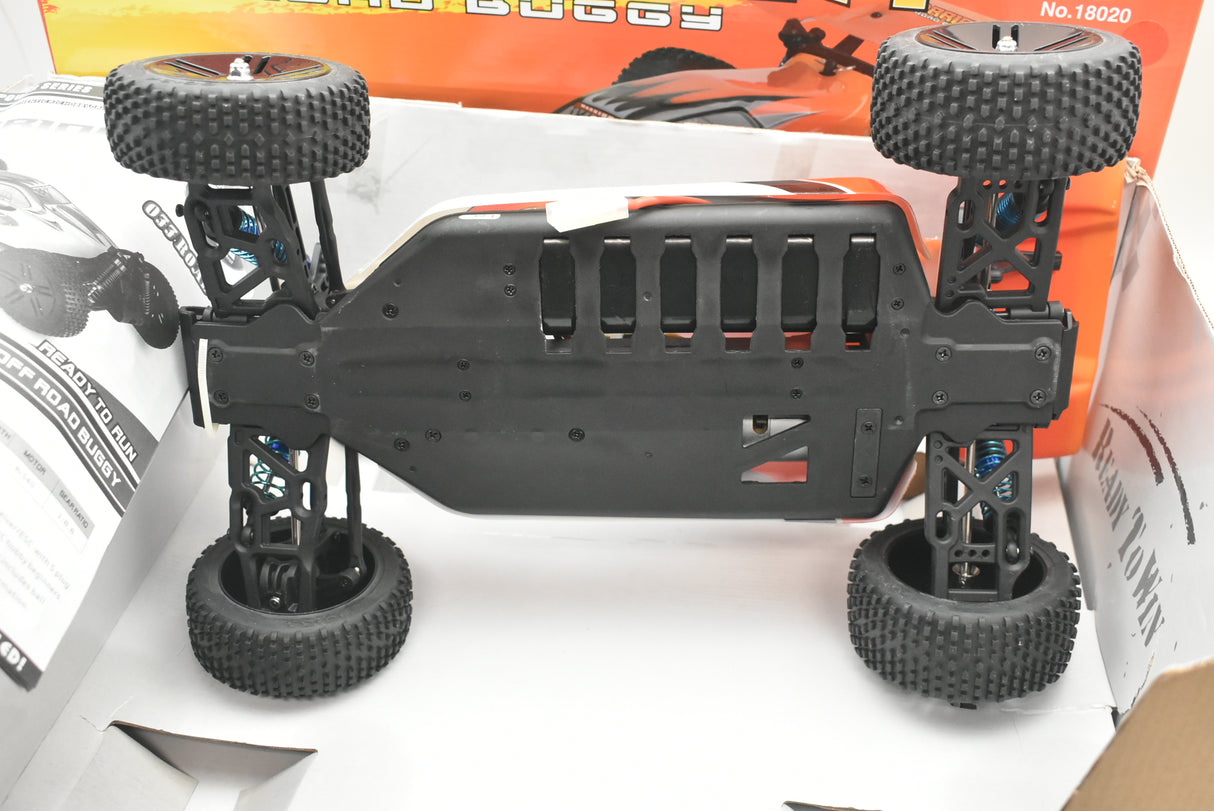 Black RC buggy chassis with four large, black rubber wheels for IMEX 18020