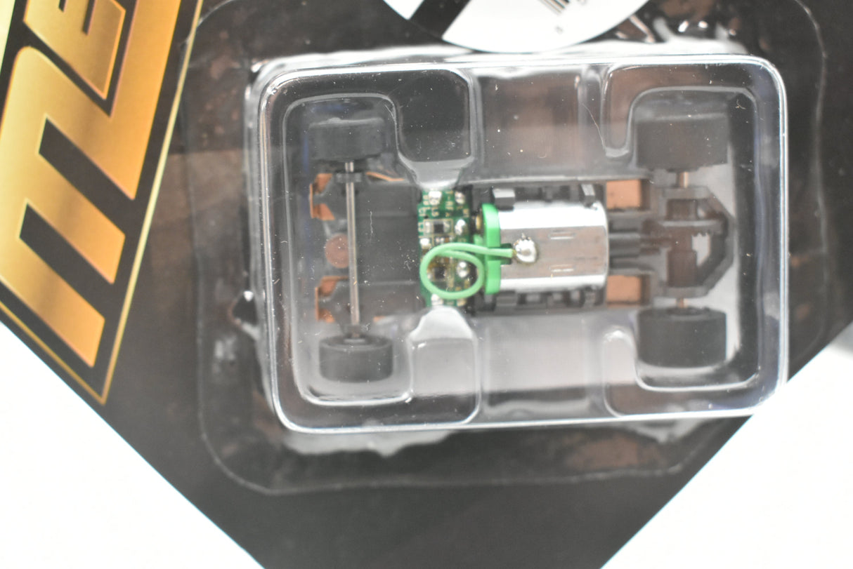 Chassis components visible in clear plastic case for AFX/Racemasters 21023