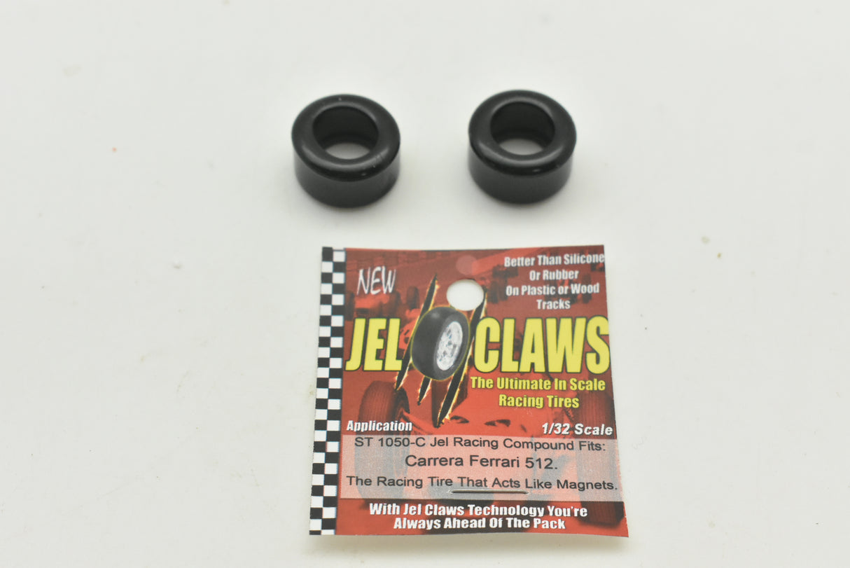 Two black wheels and a product package for 1:32 scale racing tires for Carrera Ferrari 512