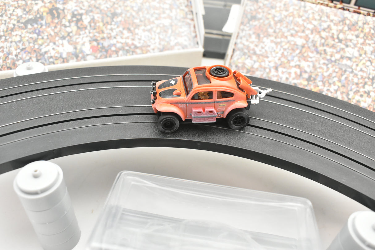 Orange VW Beetle race car on a black track section for Auto World SC011