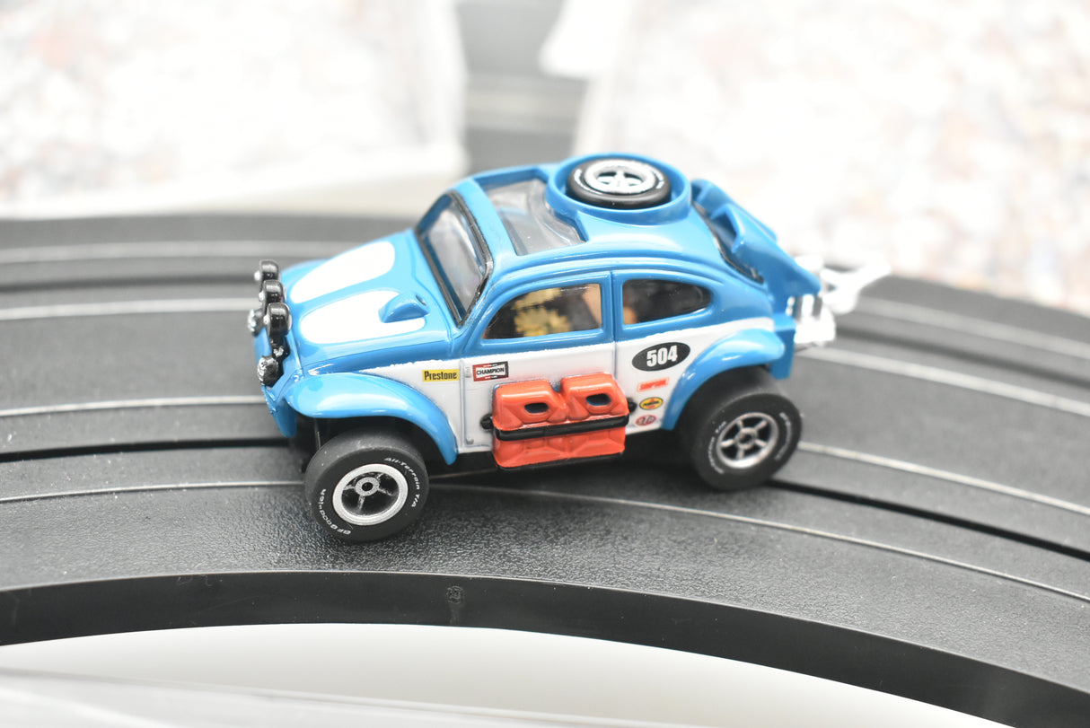 Blue VW Beetle race car on a track, dirt effect detail for Auto World SC012