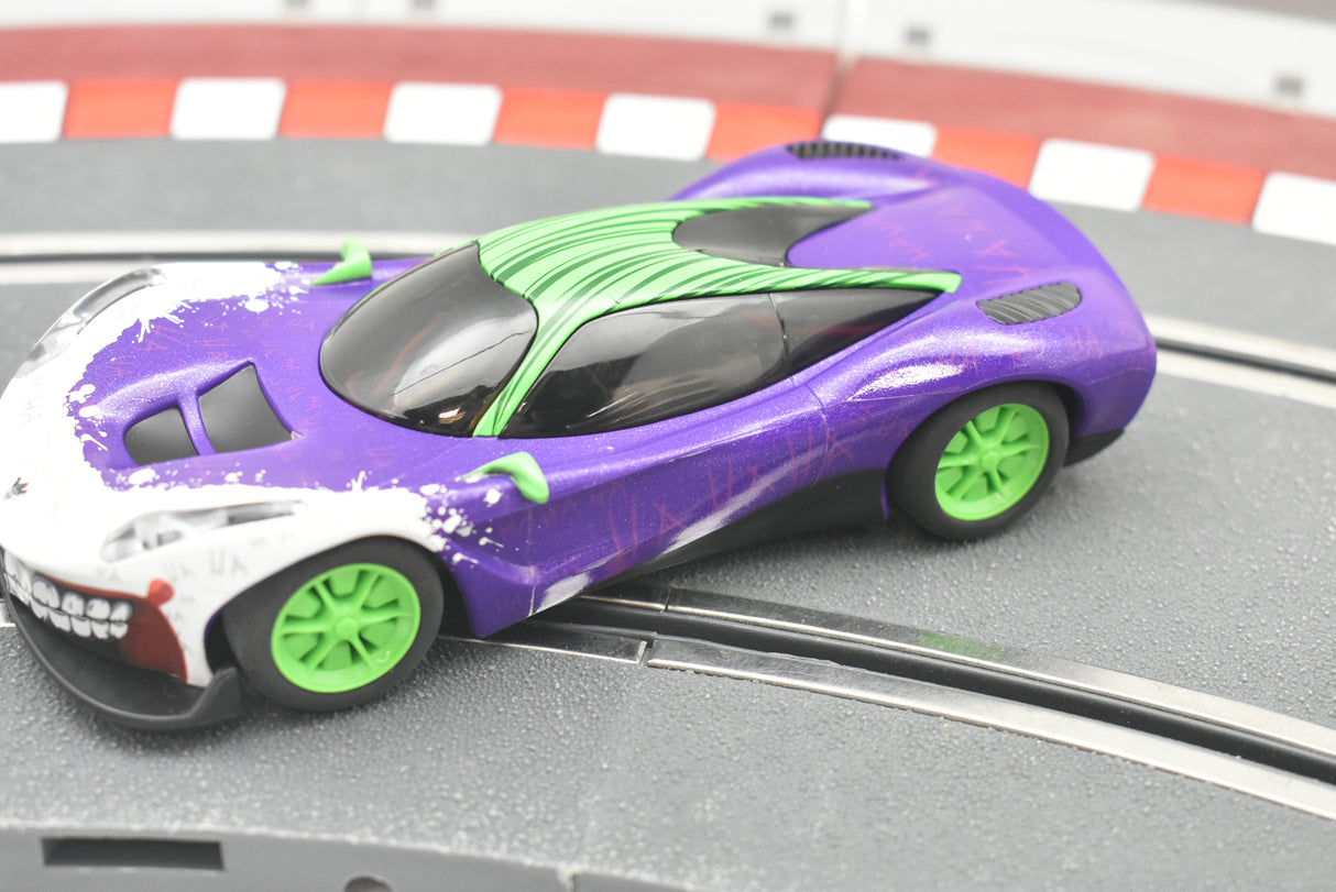 Purple and white Joker-inspired race car on a track for Scalextric C4142T
