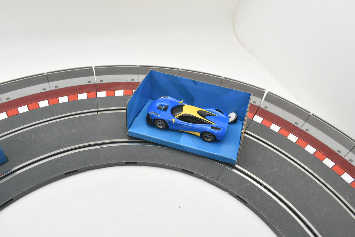 Blue and yellow race car on a track section for Scalextric C4141T