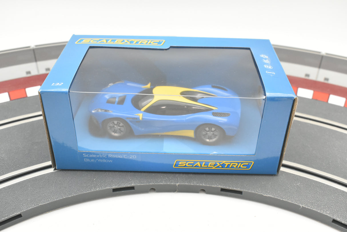 Blue and yellow model car in its box on a train track for Scalextric C4141T