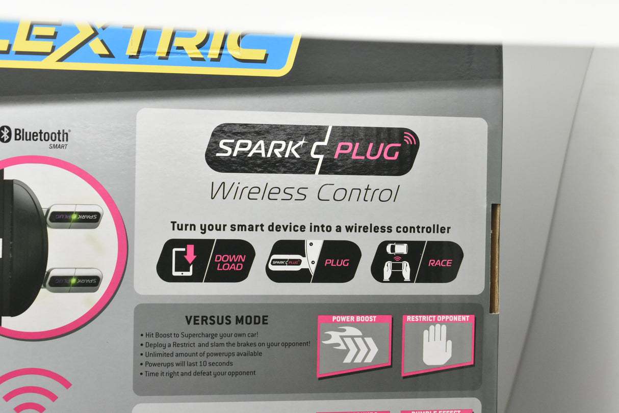 Remote control unit showing "Spark Plug" branding and control buttons for Scalextric C415