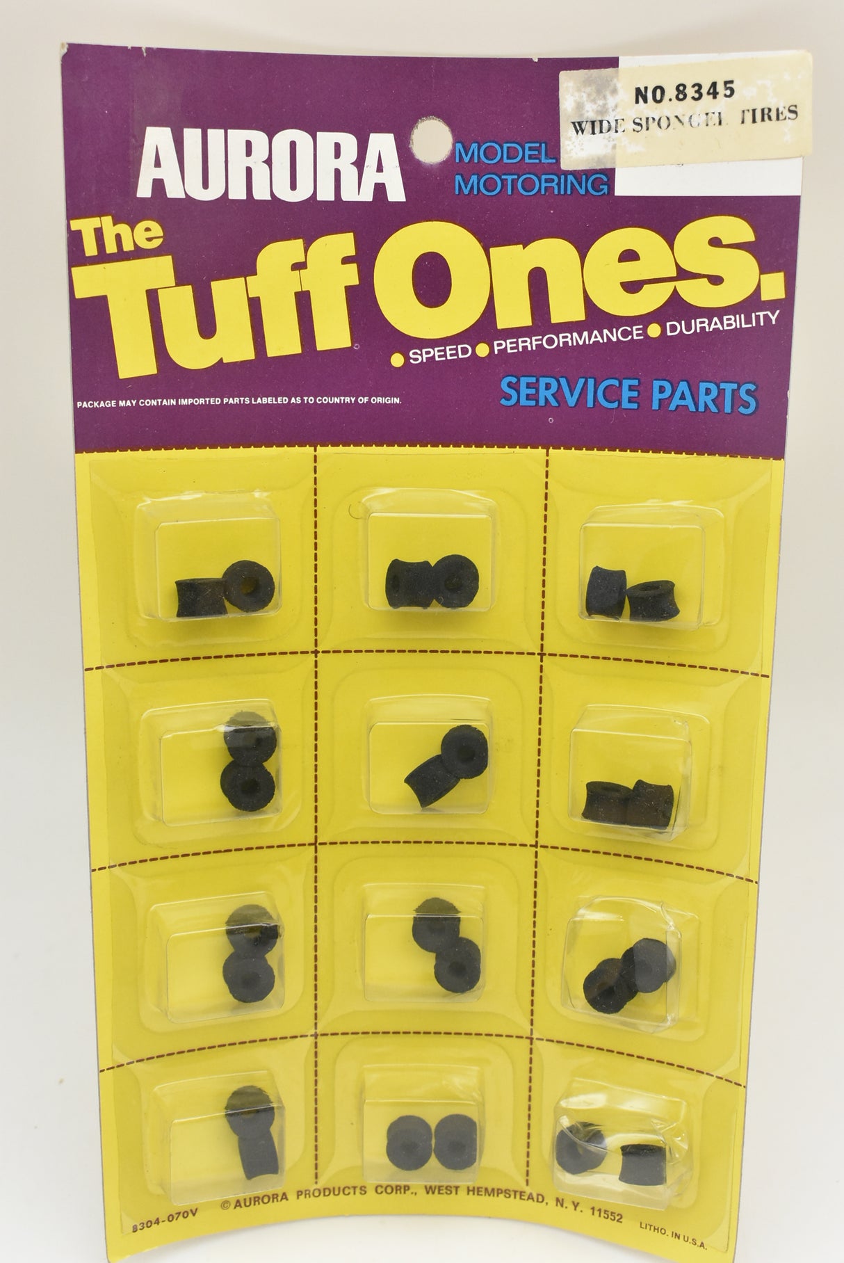Assortment of small, black, sponge-like tires in a yellow plastic card for Aurora Model Motoring 1 card of 12/Pk