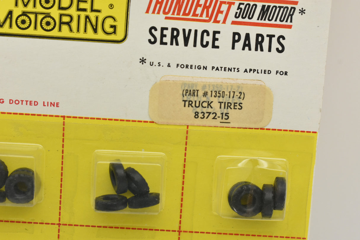 Tire parts laid out in plastic packaging for model motor service for Aurora Model Motoring 8372-15