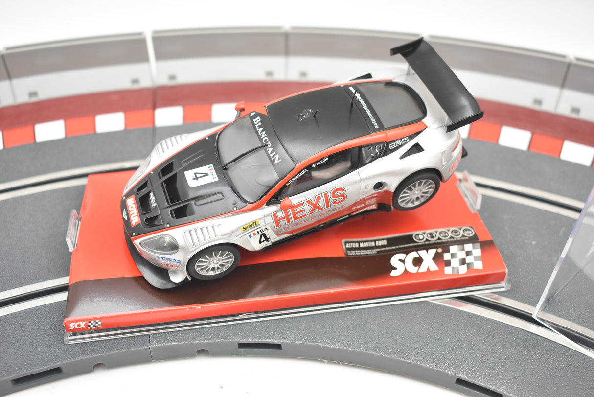 Silver Aston Martin race car on a track section for SCX A10141X3U0