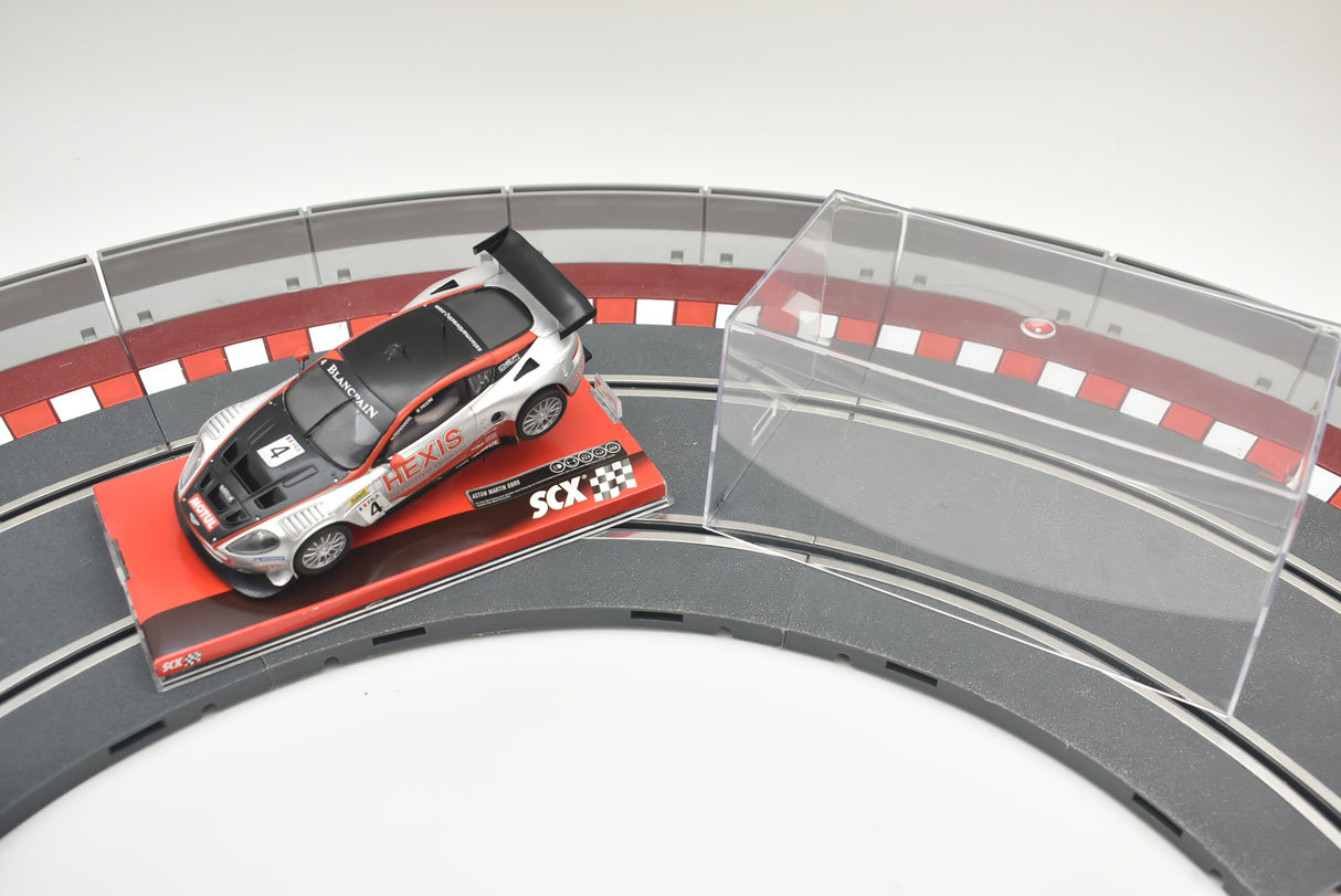Black and white Aston Martin race car on a track section for SCX A10141X3U0