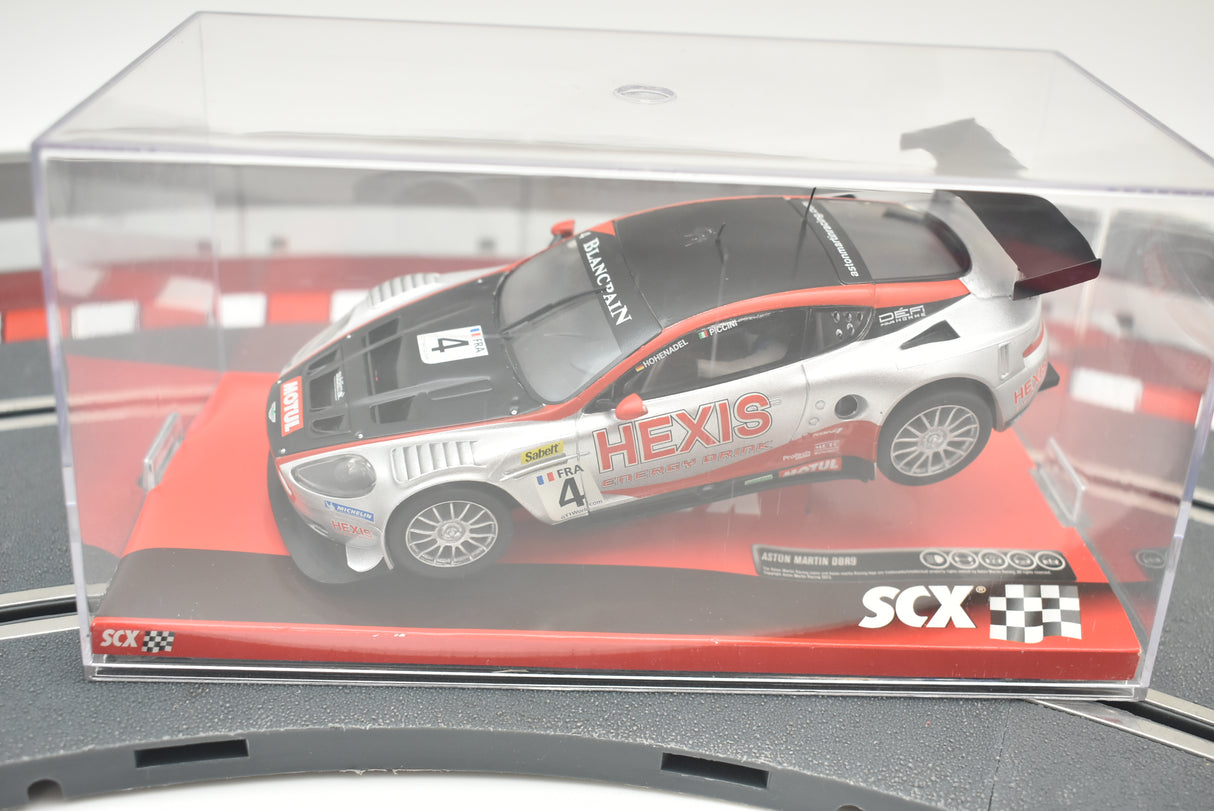 Silver Aston Martin race car model in clear display case for SCX A10141X3U0
