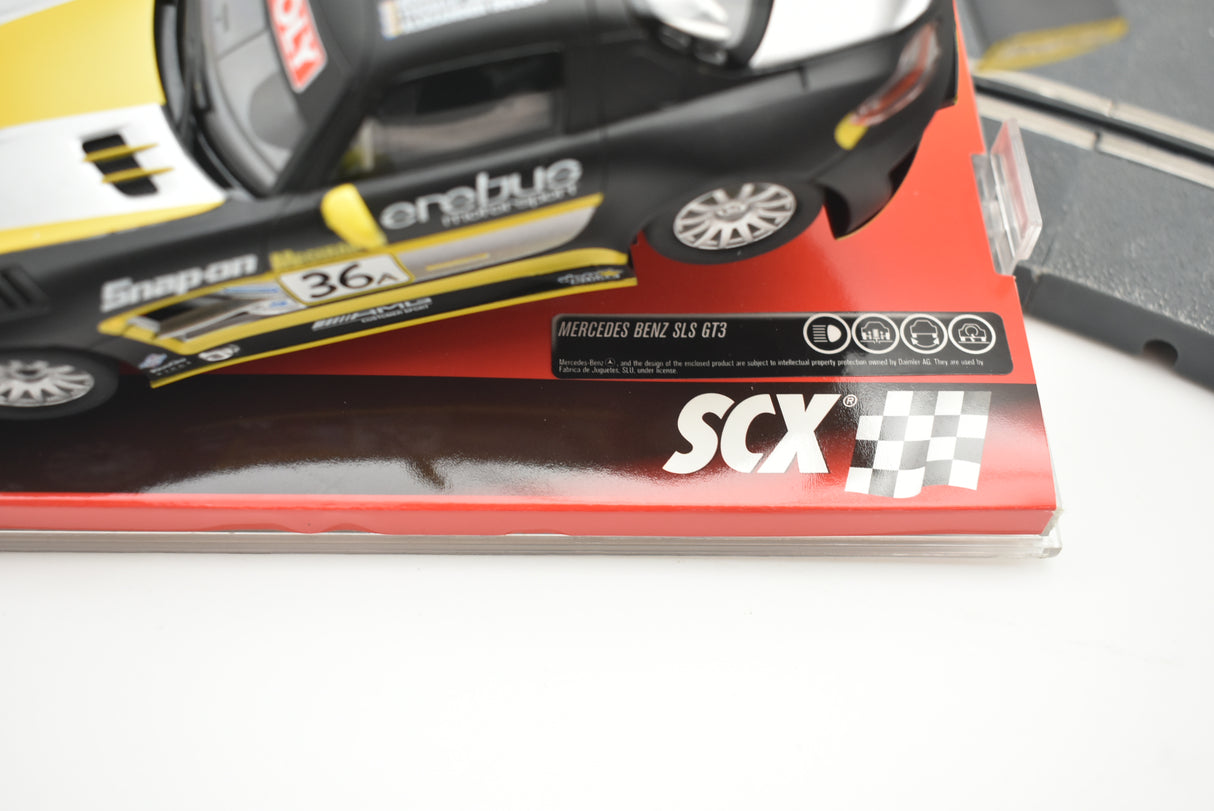 Black and yellow race car model with "Erebus" branding on a red base for SCX A10154X3U0
