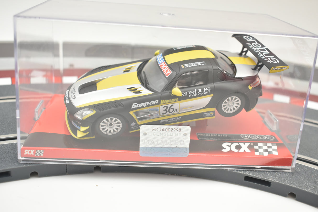 Yellow and black Mercedes SLS GT3 race car on a display base for SCX A10154X3U0