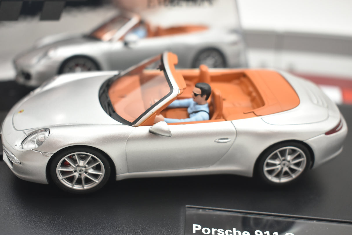 Silver convertible model with driver figure, displayed on a stand for Carrera 27535