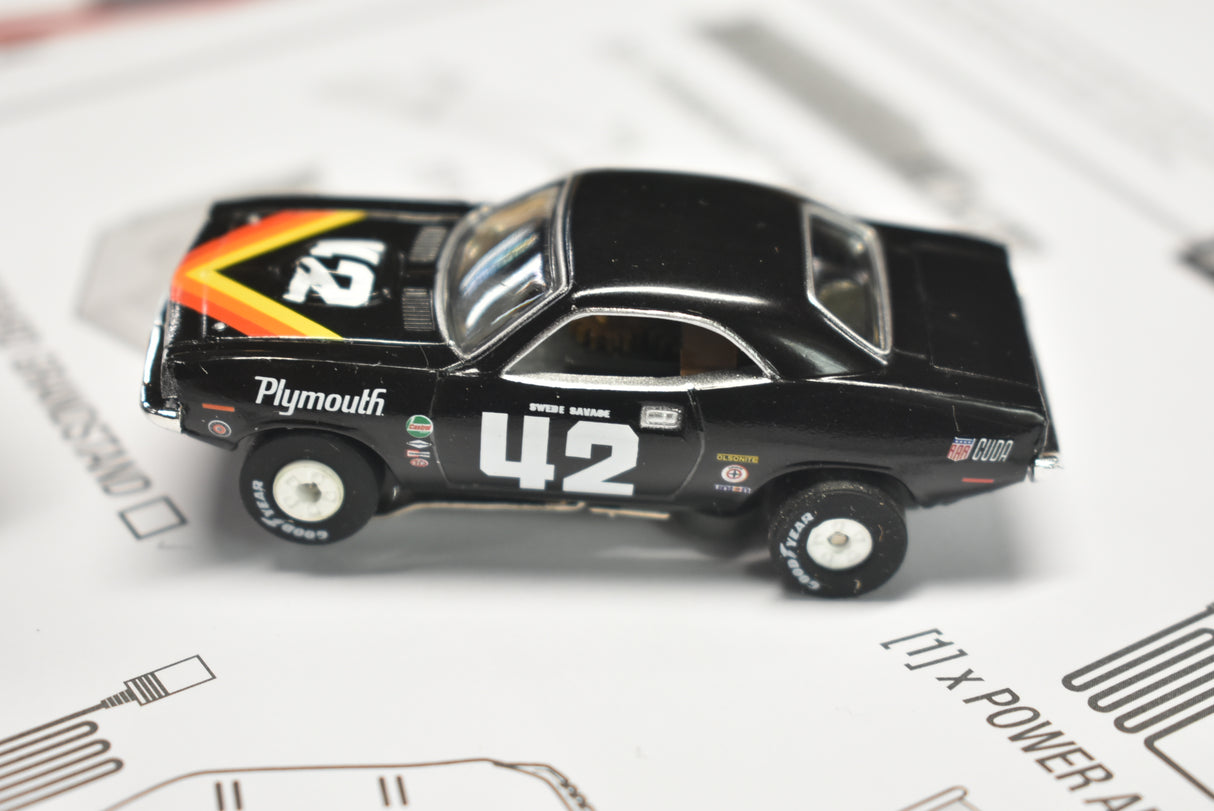 Black Plymouth race car model on white paper background for Auto World SRS326, front view