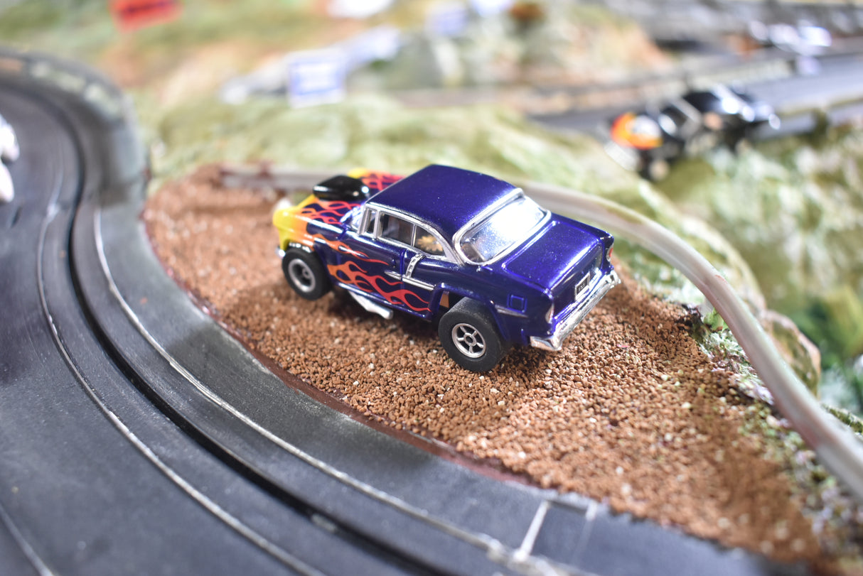 Blue 1955 Chevy Bel Air slot car on a miniature track for Slot Car 1:64 CP7726