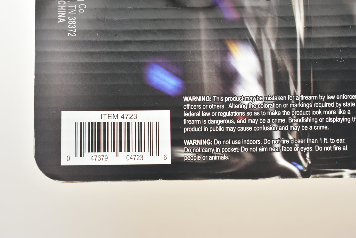 Product packaging showing a toy pistol with safety warnings for Parris Toys 4723