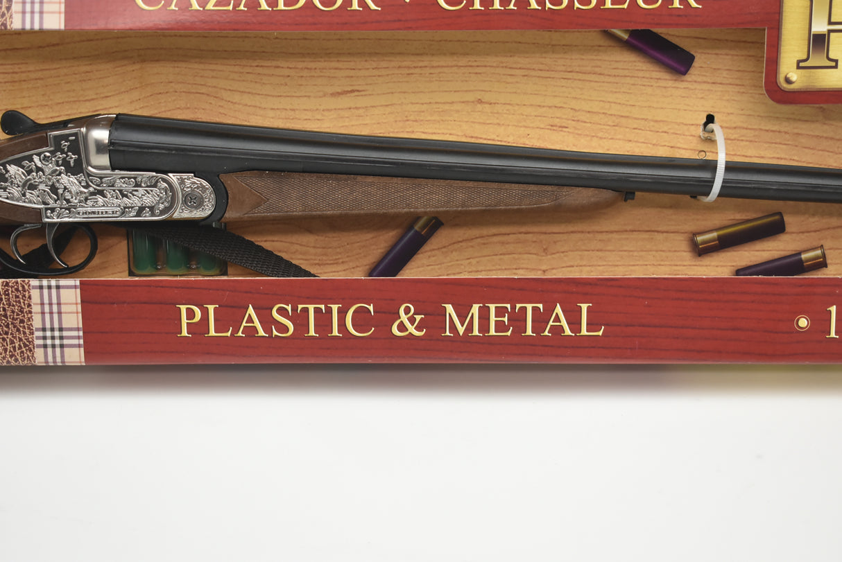 Side-by-side shotgun displayed on a book titled "Plastic and Metal." for Gonher 111/0