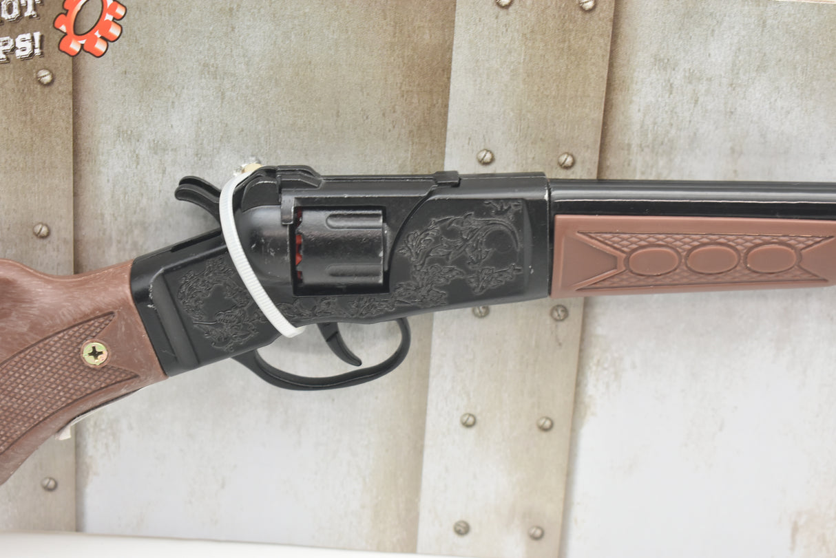 Toy rifle with brown stock and black barrel, displayed on metal surface for Parris Toys 4722