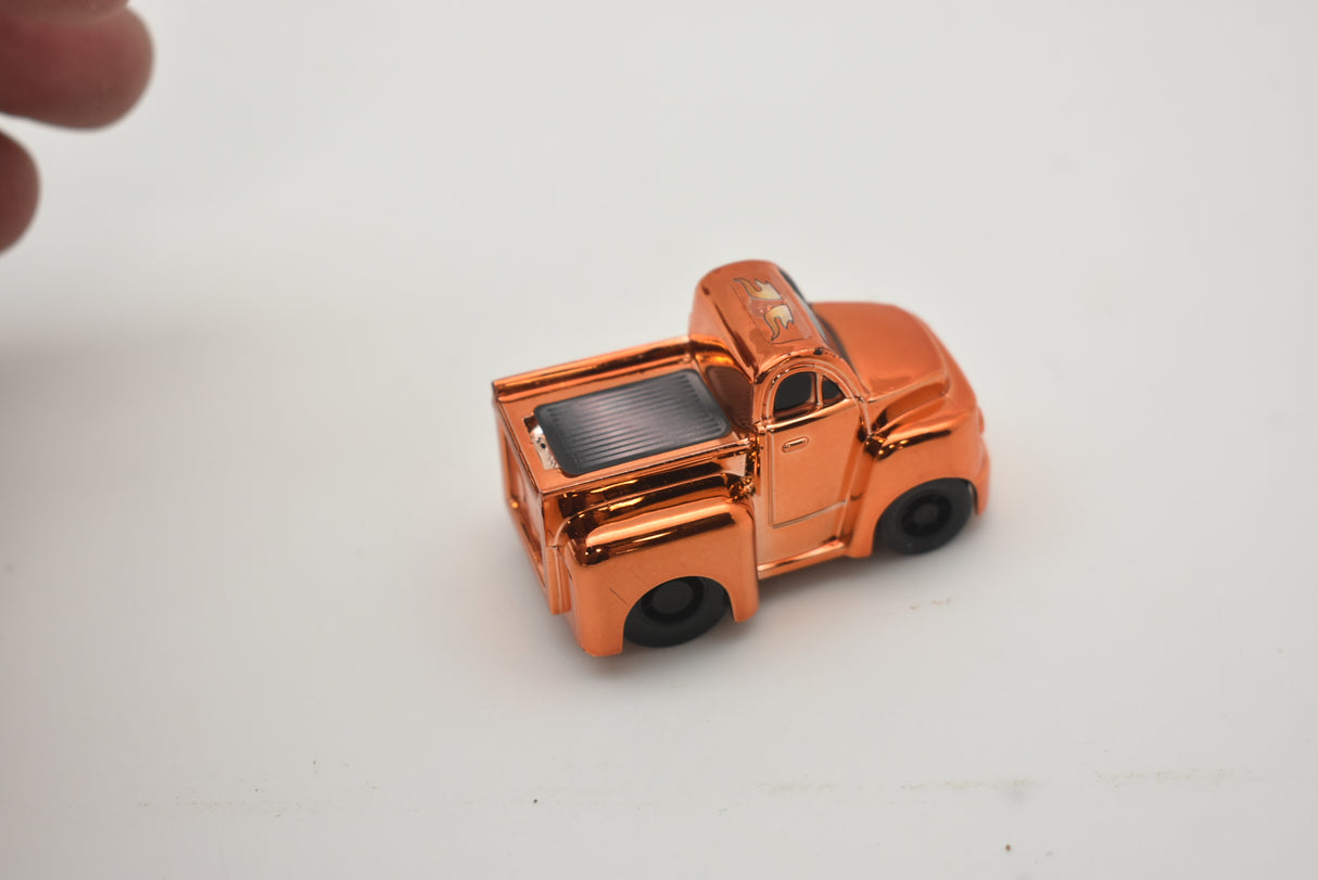 Small, orange toy truck with black wheels on a white surface for California Creations 20553