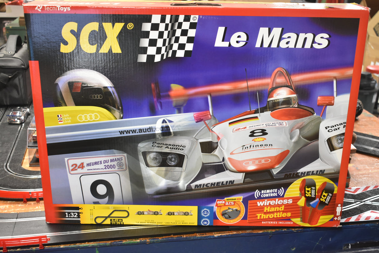 Slot car set box featuring Le Mans race cars and remote control details for SCX 80500