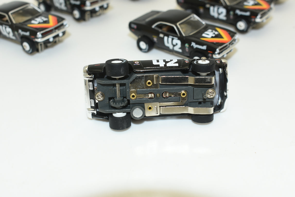 Black slot car replica of a 1970 Plymouth 'Cuda, viewed from the side for Slot Car 1:64 SC338