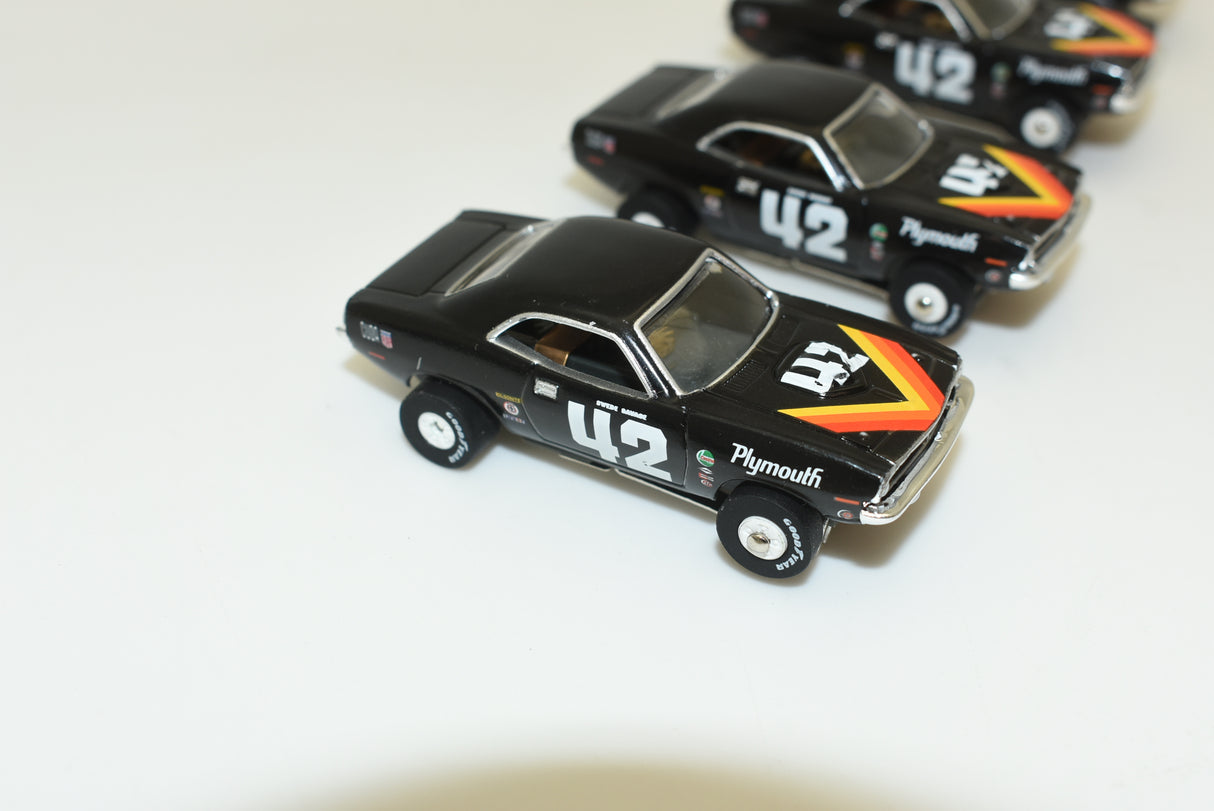Black 1:64 scale Plymouth 'Cuda slot car with yellow and black decals for Slot Car 1:64 SC338