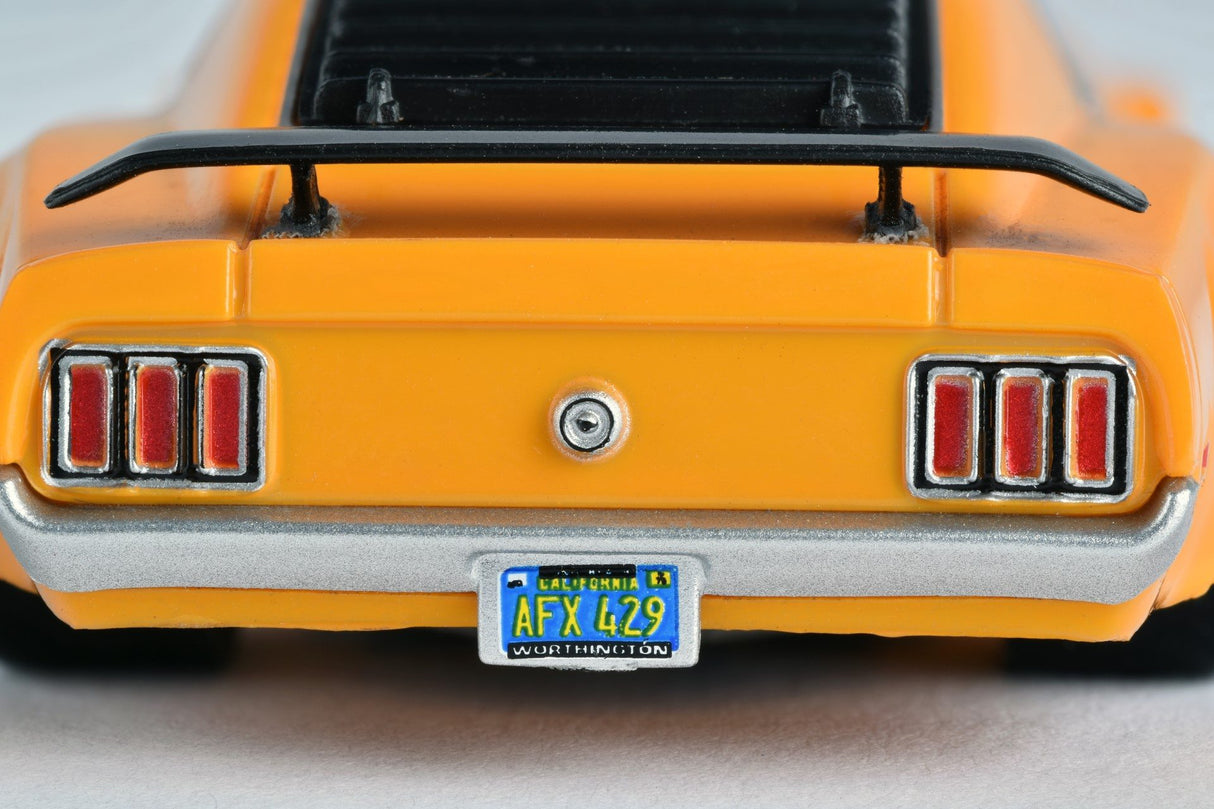 Rear view of a yellow Ford Mustang toy with dual taillights and license plate for AFX/Racemasters 21050 / 21017