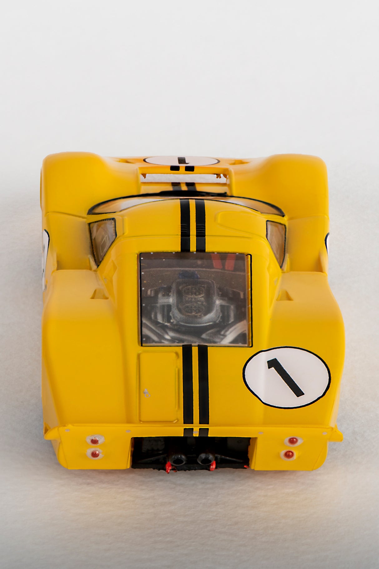 Yellow Ford GT40 race car model with black stripes and a number '1' decal for AFX/Racemasters 22025