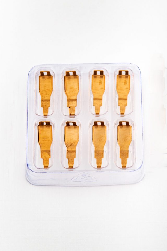 Set of ten gold-colored shoe laces in a clear plastic case for AFX/Racemasters 22028