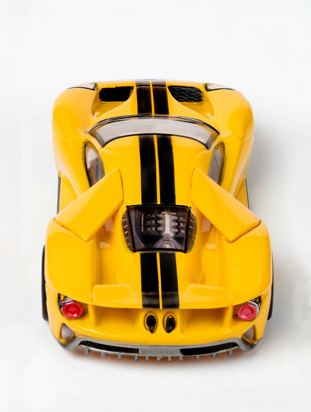 Yellow slot car replica of a Ford GT with black racing stripes for AFX/Racemasters 22029 / 21007