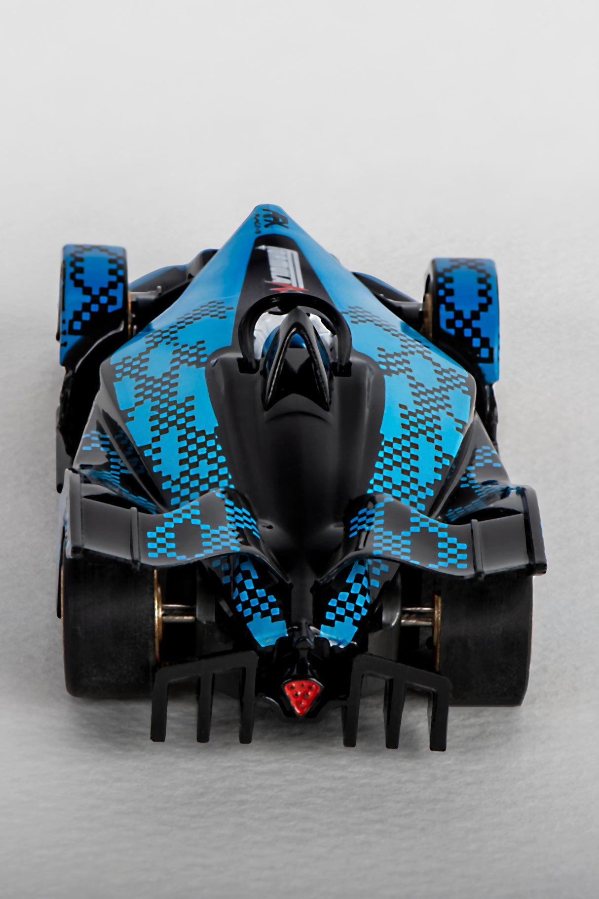 Blue and black race car model with checkered pattern on the body for AFX/Racemasters 22039