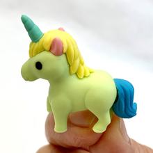 Yellow unicorn eraser with blue mane and horn, held in hand for BC Mini 38293