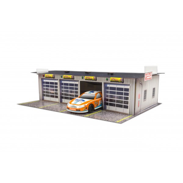 Model kit of a four-stall pit garage with a race car displayed for Innovative Hobby Supply BK4811