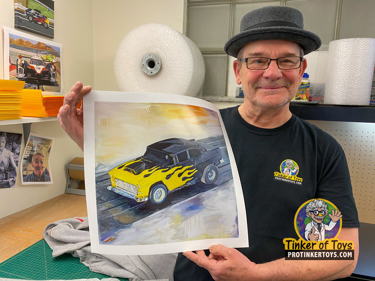 Man holds art print of yellow '55 Chevy Bel Air slot car for Timothy W. Young 14”x14”