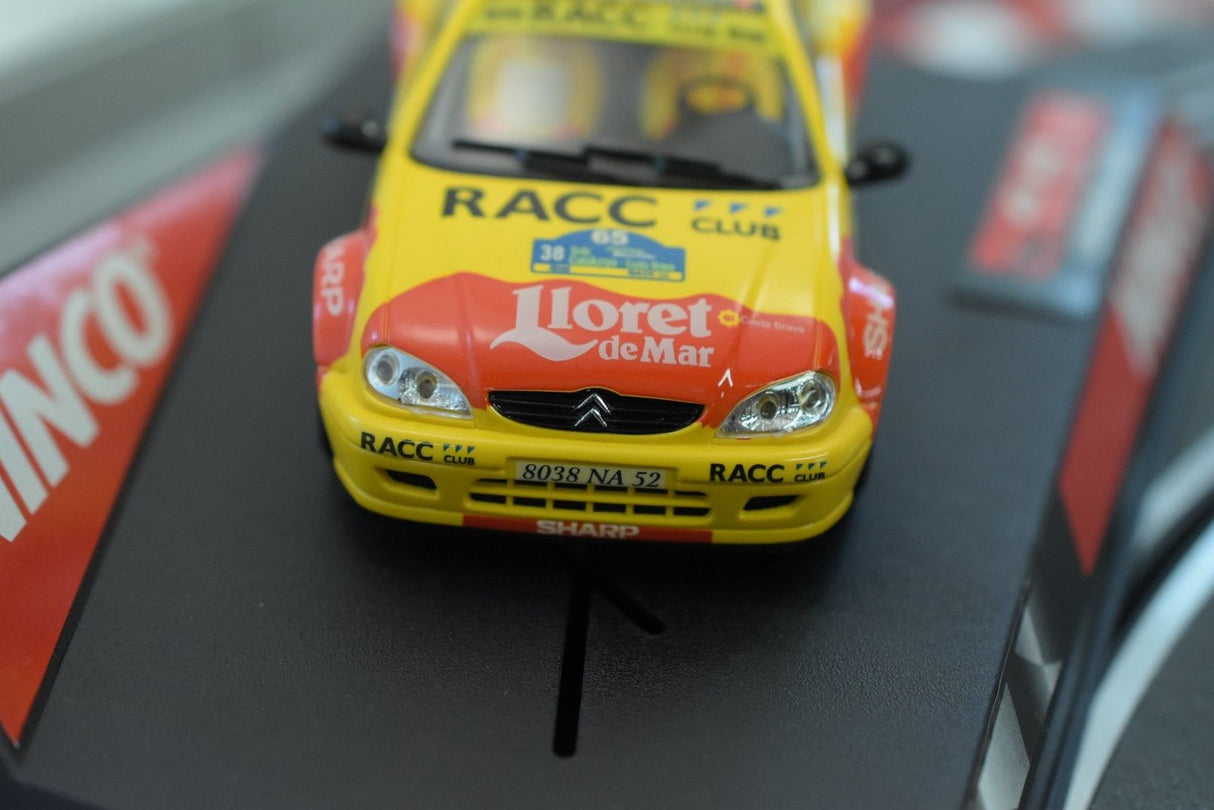 Yellow model car of a Citroen Saxo JWRC, featuring "RACC" decals for Ninco 50266, rear view