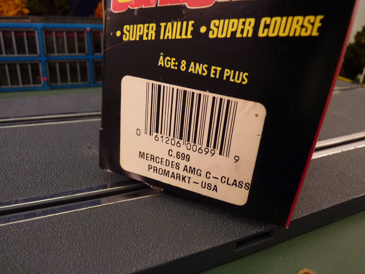 Product box showing Mercedes AMG C-Class model details and barcode for SCX C.699