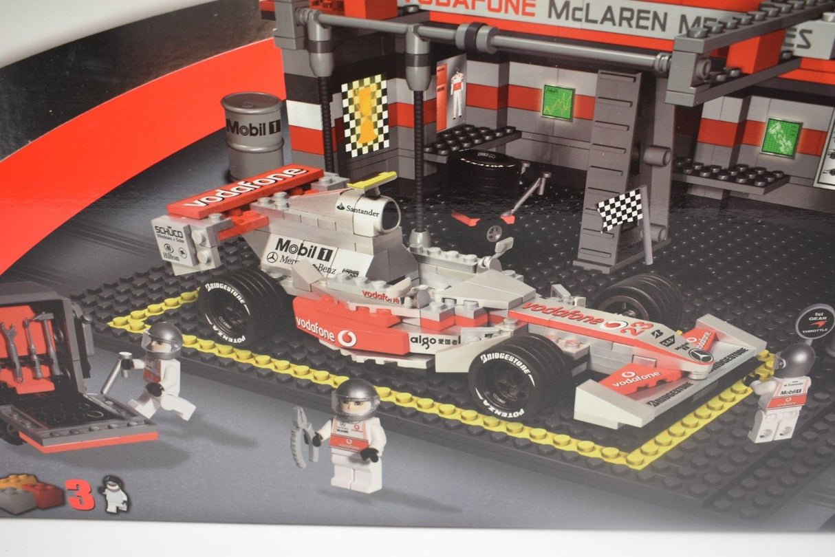 Race car model built with bricks, featuring a team pit area backdrop for COBI COBI22550