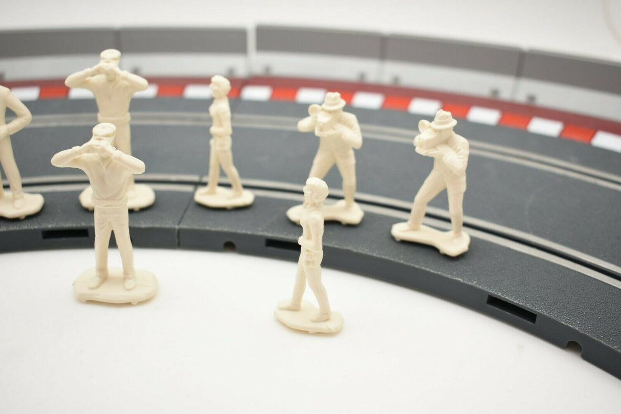 Unpainted 1/32 scale figures of motor racing spectators lined up for HORNBY 303058821440, front view