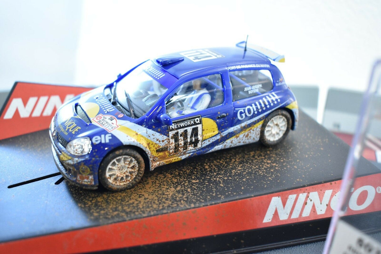 Dirt-covered Renault Clio race car model on a black track for Ninco 50313