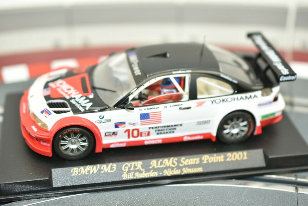Slot car of a 2001 BMW M3 GTR race car on a display base for Fly Car 99001, rear view