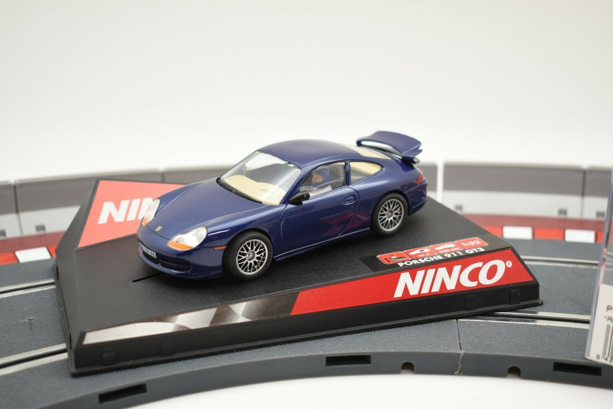 Blue slot car of a Porsche 911 GT3 on a track section for NINCO 50234