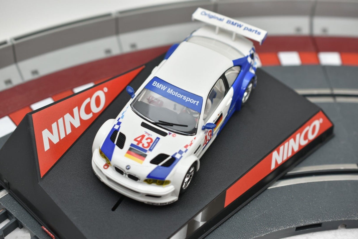 White BMW M3 GTR slot car on a black track section for REH Ninco 50271