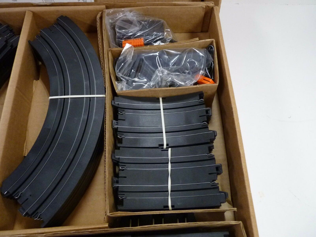 Black model train track pieces in a cardboard box for Aurora / AFX / Tomy 9115M, package view, product view 9