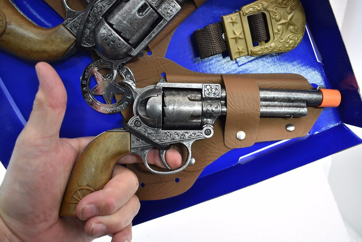 Hand holding a replica revolver from a Texas Ranger double holster set for Parris Toys 4618, front view