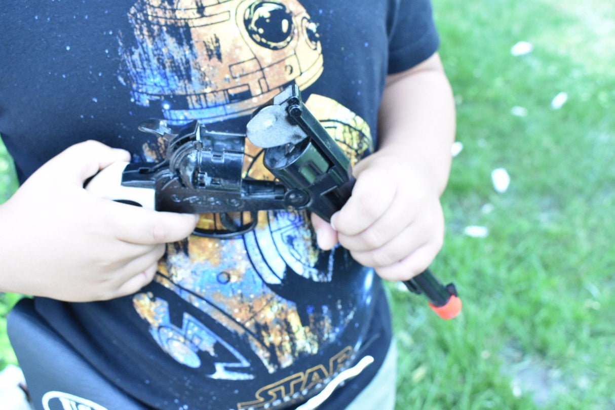 Child holding a toy revolver and holster against a graphic t-shirt for Parris Toys 0652