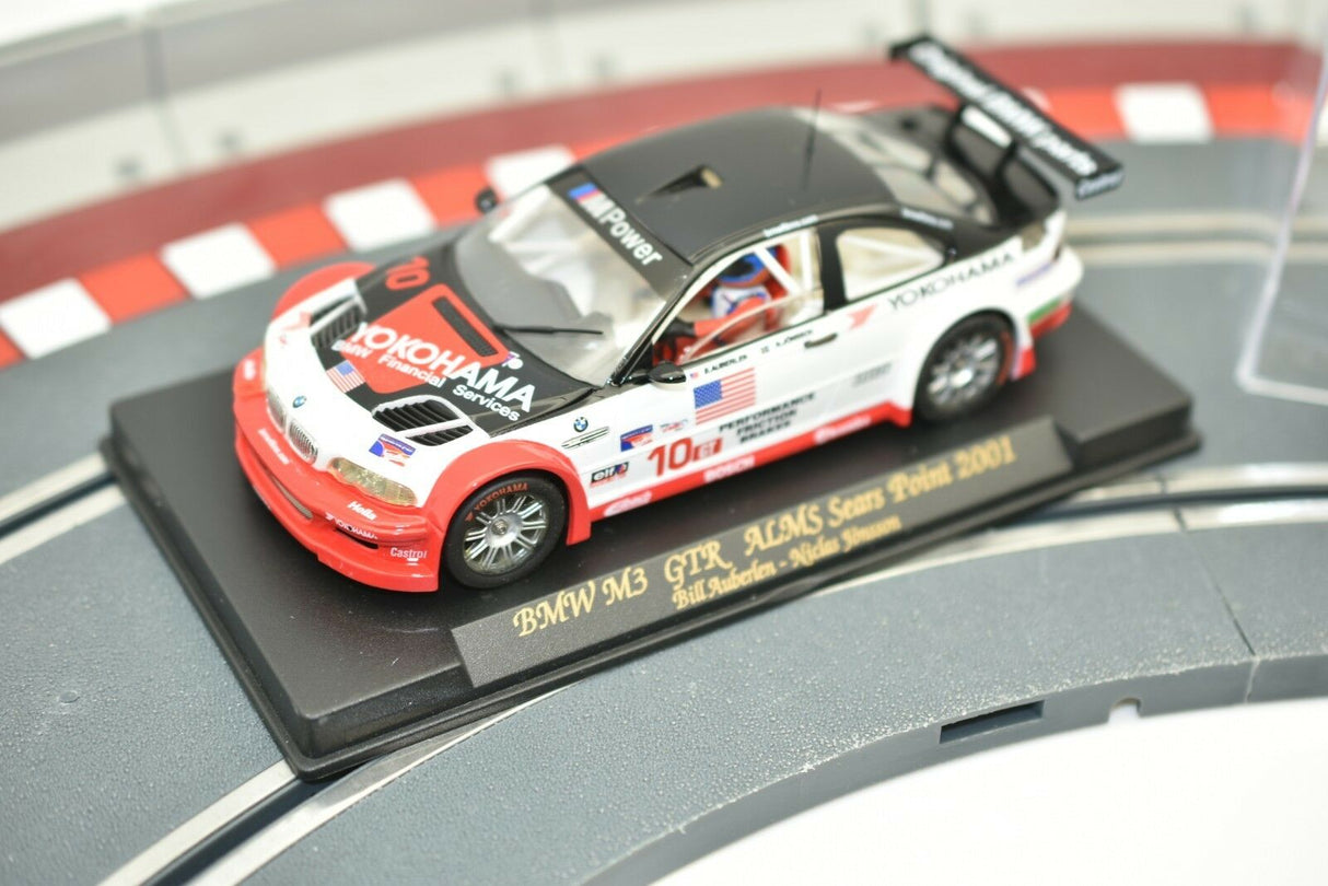 Slot car of a 2001 BMW M3 GTR race car on a track base for Fly Car 99001, alternate track view