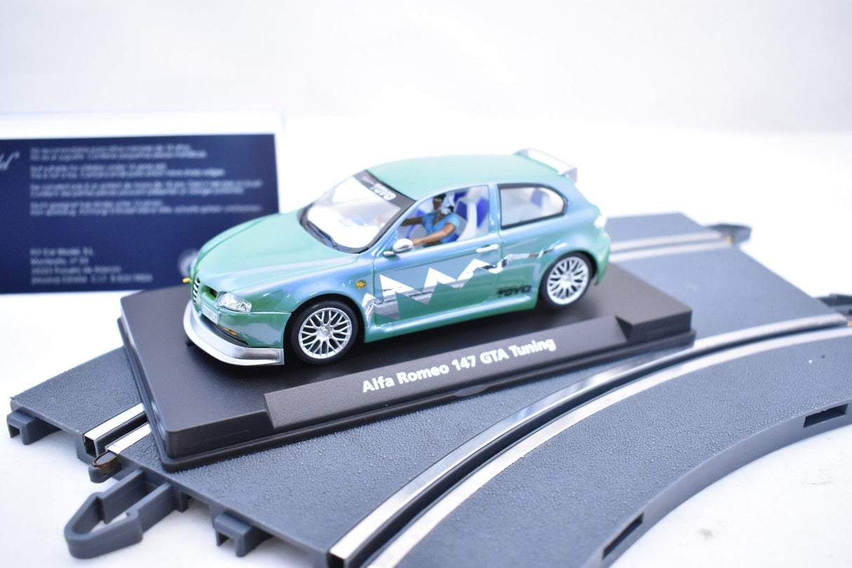 Green slot car on a black base with tracks for Fly Car 07049
