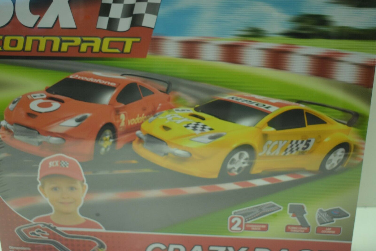 Orange and yellow race cars on a track background for SCX Compact C10125X5U0