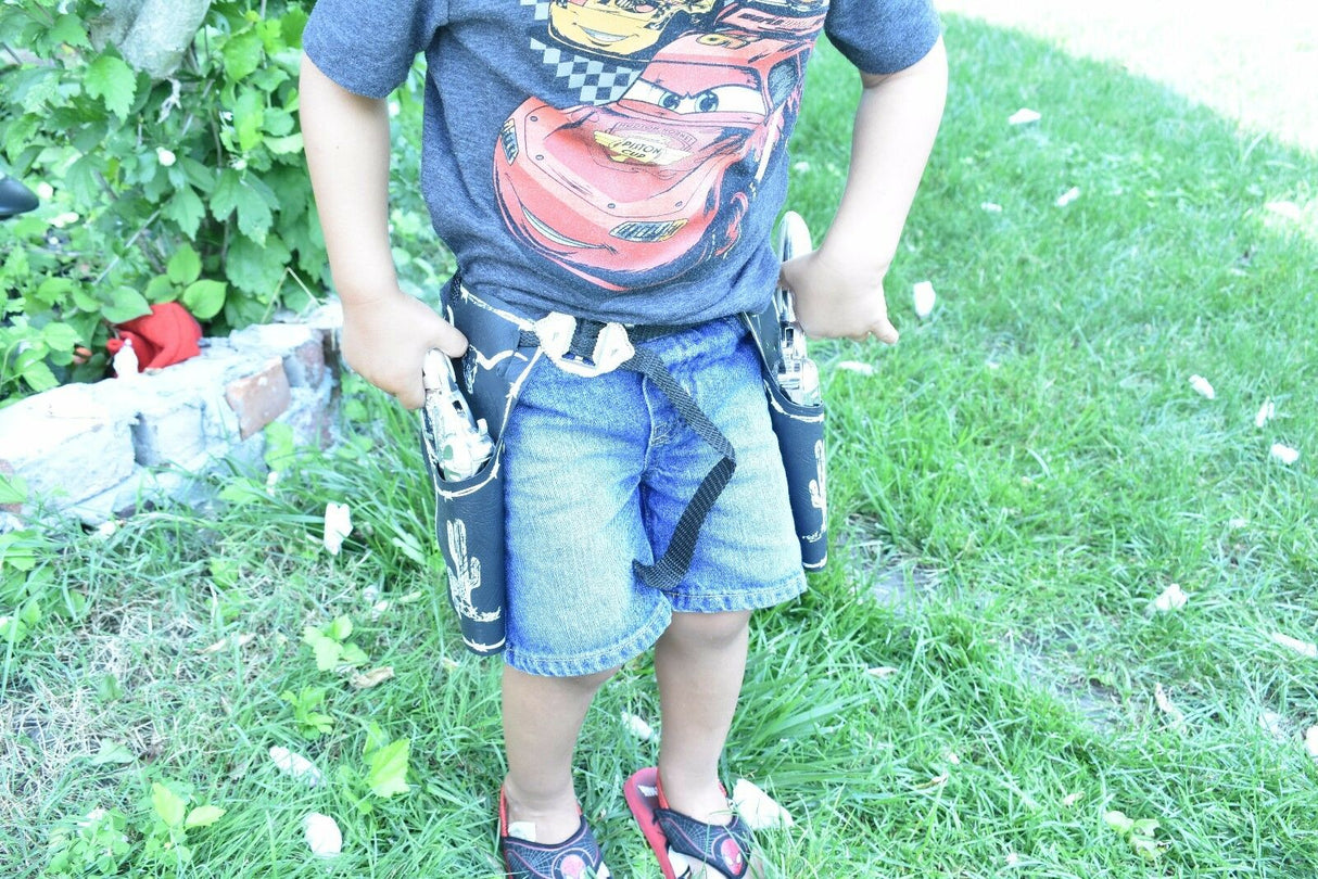 Boy wearing a graphic tee and holster belt with toy pistols for Parris Toys 5506