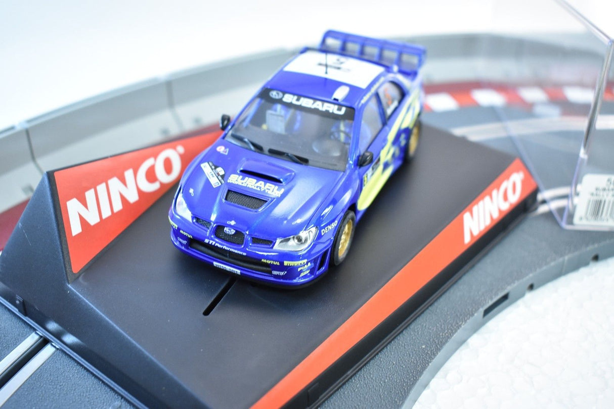 Blue Subaru WRC 2006 slot car on a track section for ZZ Expired Kim Collection 50431, alternate track view